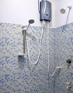 a shower in a bathroom with a phone on the wall at Wilpattu Gagana guest in Nochchiyagama +121 photos
