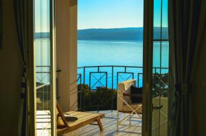 a room with a view of the ocean from a balcony at Rooms Villa Harmonie - Adults Only +14 in Crikvenica