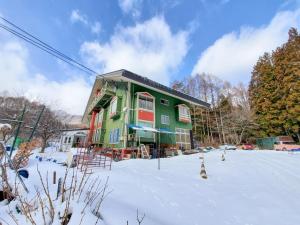 a green and red building in the snow at 横磐梯リロード in Inawashiro