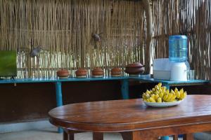 a bowl of bananas sitting on a wooden table at Unawa Retreat in Tissamaharama
