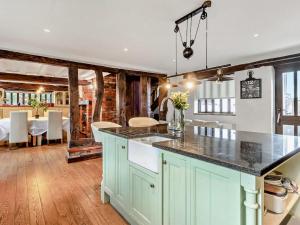 a kitchen with a counter top and a dining room at The Farmhouse - Uk48228 in Tibenham