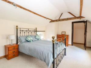 a bedroom with a bed and a dresser and a mirror at The Farmhouse - Uk48228 in Tibenham