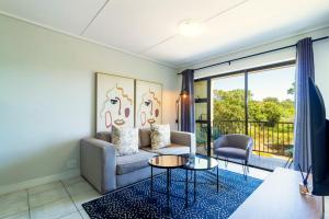 a living room with a couch and a table at #Alimama Spaces The Future at Greenlee in Sandton