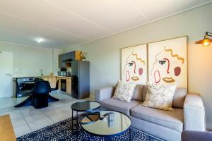 a living room with a couch and a table at #Alimama Spaces The Future at Greenlee in Sandton