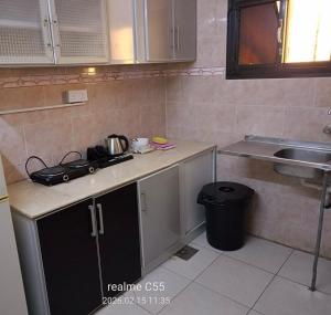 a small kitchen with a counter and a sink at جمانا سويتس للشقق المخدومه in Al Qunfudhah
