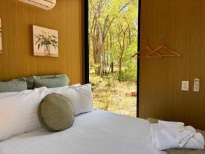 a bedroom with a bed and a window with a view at Gum Tree Hideaway by Tiny Away in Stoneville