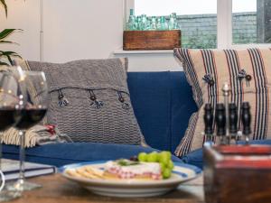 a table with a plate of food and a plate of grapes at The Salt Loft in Fowey
