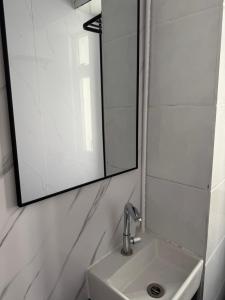 a bathroom with a sink and a mirror at 旅居2wubin in Hong Kong +1 photo