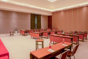 a large room with tables and chairs in it at Amaris Hotel Gorontalo in Gorontalo