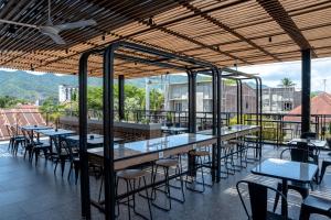a row of tables and chairs on a patio at Amaris Hotel Gorontalo in Gorontalo