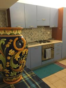 a kitchen with a large vase sitting on the floor at Loft Rapisardi in Catania