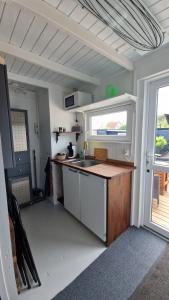 a small kitchen with a sink and a window at Nalle's in Stavtrup