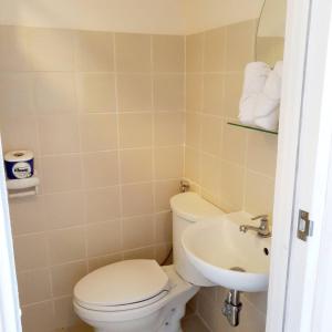 a bathroom with a toilet and a sink at Cozy Studio Condo with Stunning Tagaytay Views in Tagaytay +17 photos