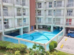 an overhead view of a building with a swimming pool at Cozy Studio Condo with Stunning Tagaytay Views in Tagaytay