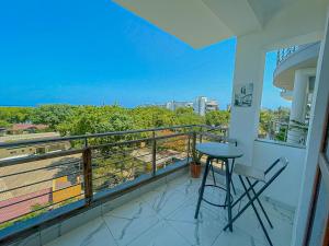 a balcony with a stool and a view of the city at Aqua kingstone apartments in Mombasa