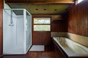 a bathroom with a bath tub and a window at Kelora Bush Camp in Hoedspruit +32 photos