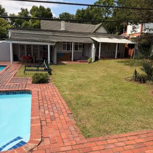 a house with a yard with a swimming pool at Eagles Enest BnB in Pietermaritzburg