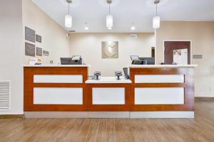 an empty waiting room with a cash register at Comfort Inn & Suites Montgomery East Carmichael Rd in Montgomery +58 photos