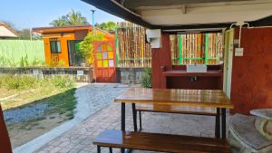 a wooden table and bench in front of a house at Thung Setthi Homestay&Cafe4 in Chiang Dao