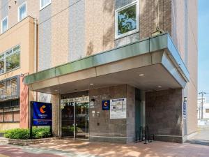 a building with a sign in front of it at Comfort Hotel Maebashi in Maebashi