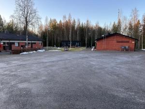 a parking lot in front of a building at Kangaskartano Yksiö in Keitelepohja