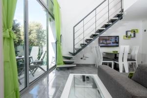 a living room with a couch and a table at Apartments Mali Stradun in Dubrovnik