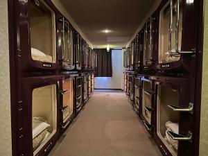 a row of glass shelves in a library at ファーストイン高松 First Inn Takamatsu in Takamatsu +53 photos