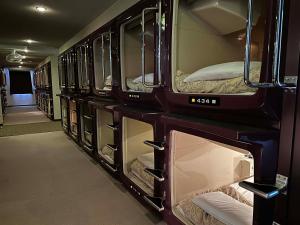 a group of bunk beds in a room at ファーストイン高松 First Inn Takamatsu in Takamatsu