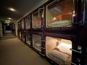 a group of bunk beds in a room at ファーストイン高松 First Inn Takamatsu in Takamatsu