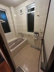a bathroom with a tub and a window at 南国リゾートBari Okinawa in Itoman +16 photos