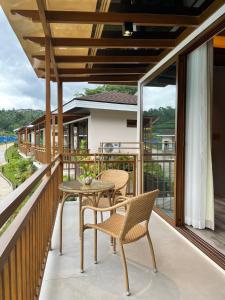a patio with a table and chairs on a balcony at Kenjelo Farm and Recreation Resort in Dullan