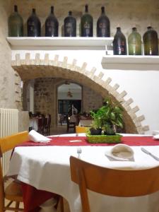 una sala da pranzo con tavolo, sedie e vasi di Agriturismo Sorgente di Luna a Larino