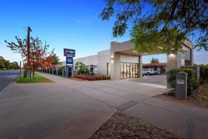 a building with a gas station on a street at Comfort Inn Deakin Palms in Mildura