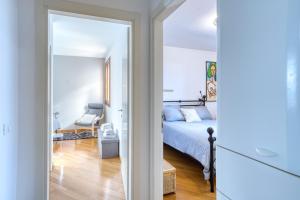 a bedroom with a bed and a living room at Casa Altea in Pordenone