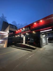 a hotel entrance with red lights on a building at Hotel Fênix II Butantã in São Paulo