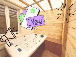 a bathroom with a bath tub with a new sign at Location Maison Larmor plage in Larmor-Plage +19 photos