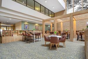 a restaurant with tables and chairs in a lobby at Radisson Hotel Philadelphia Northeast in Trevose