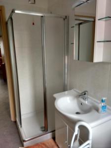 a bathroom with a shower and a sink at Gardens House in Varenna +10 photos