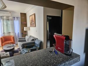 a room with a living room with a couch and a living room with a room at Résidence Ephrata in Cocody