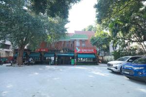 a parking lot with cars parked in front of a building at Sun Stayz Inn T - Nagar Chennai in Chennai