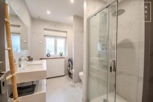 a bathroom with a shower and a sink and a toilet at Philippe chez l'habitant in Maubeuge +10 photos