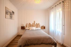 a bedroom with a large bed with a large window at Philippe chez l'habitant in Maubeuge