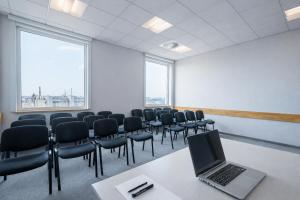 a conference room with a laptop on a table and chairs at Weiser Hotel in Wrocław +26 photos