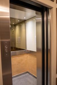 a elevator in a building with a mirror at Frederick House Hotel in Edinburgh