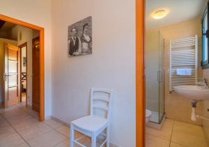a bathroom with a chair and a sink at Cal Metge de Gualba in gualba de Dalt +45 photos