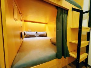 a bedroom with a bunk bed in a room at Coller Chinatown in Singapore