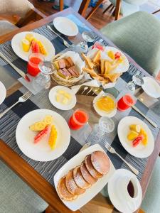 a table with plates of breakfast food on it at Kavi s Hideaway in Dedugala