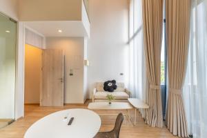 a living room with a couch and a table at Heaven Sukhumvit 62Villa in Bangkok
