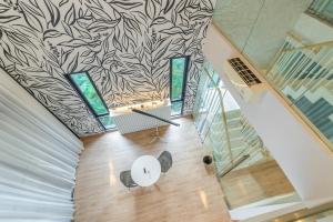 an overhead view of a living room with a wall at Heaven Sukhumvit 62Villa in Bangkok +46 photos