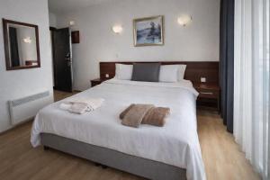 a bedroom with a large bed with towels on it at Villa Mesokastro in Ohrid